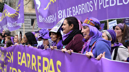 Madrid/Spain, 2020-03-08. Women of all ages dressed in purple hold large banners. In one of them it saysのeditorial素材