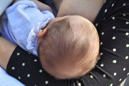 Close up of a young mother breastfeeding her newborn baby