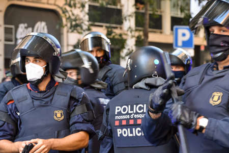 Barcelona / Spain, 2020-09-22 Neighborhood protest against the eviction of a house for non-payment of rent. A group of face masked riot police prepare to act.のeditorial素材