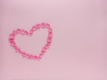 Heart of petals on a pink background. Happy Valentine's Day Greeting Cardの写真素材