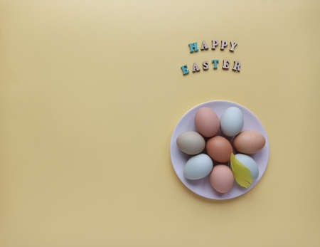 Easter holiday concept, flat layout, top view. Colorful Easter eggs on a plate.