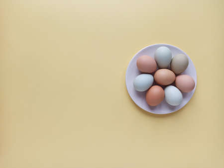 Easter holiday concept, flat layout, top view. Colorful Easter eggs on a plate.