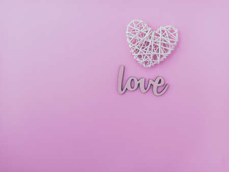 Postcard for lovers. Braided heart on a pink background.