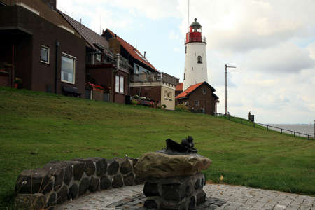 White-red lighthouse on the small fishing town Urk  Flevoland, Netherlandsの写真素材