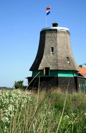 Famous picturesque Zaanse Schans in Netherlands. Group of historic old windmills . の写真素材