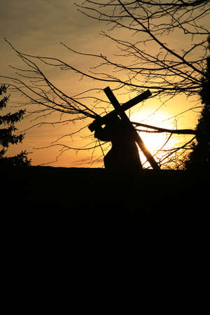 Figure of the Jesus carrying the cross. View of the silhouette at sunset . Empty space for text.の写真素材