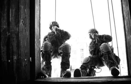 Subdivision anti-terrorist police during a black tactical exercises. Rope Techniques. Real situation. の写真素材