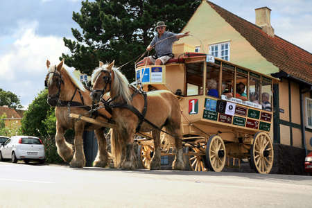Svaneke,  Denmark â August 15, 2012  Old horse tram takes tourists on the streets of the city  Touristic attraction  in Svaneke in Denmark のeditorial素材