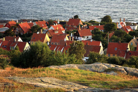 Panorama of picturesque small town Gudhjem with red roofs by early morning, Bornholm, Denmarkの写真素材
