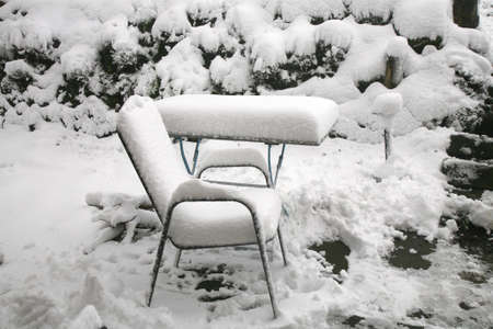 Weather anomaly. Snow in May. Garden covered with snow after snowstorm. Europe. Gloomy day.の写真素材