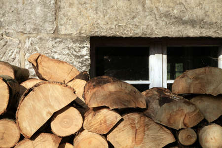 Pile of firewood. Preparation of firewood for the winter at an old farm house on the farm.