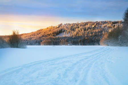 Cross country skiing. A magical start to a new day  in the meadows of the Stolowe Mountains National Park in Poland. A wonderful sunrise in a wild land.の写真素材