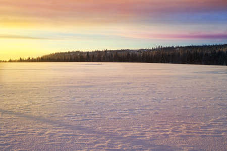 Cross country skiing. A magical start to a new day  in the meadows of the Stolowe Mountains National Park in Poland. A wonderful sunrise in a wild land.の写真素材
