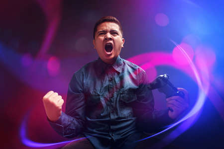 Happy young man winning the gameの写真素材