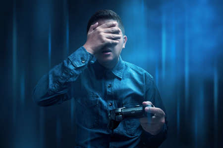 Man losing playing video gameの写真素材