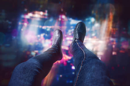 Man sitting on the rooftop of a skyscrapersの写真素材