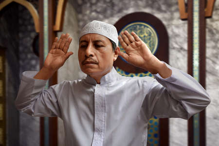Old muslim man praying in mosqueの写真素材