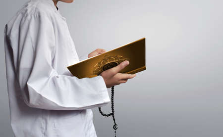 Asian muslim kid reading koran