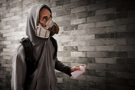 Graffiti artist wearing respirator mask