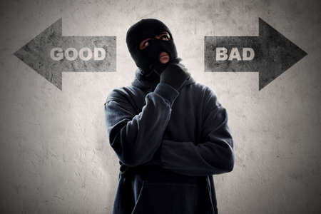 Masked thief thinkingの写真素材