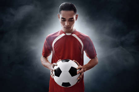 Soccer player holding soccer ballの写真素材
