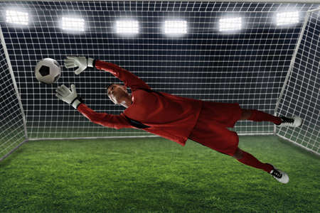 Soccer goalkeeper catches the ballの写真素材