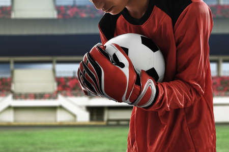 Soccer goalkeeper catches the ballの写真素材