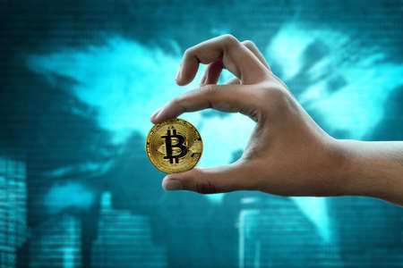 Hand holding golden bitcoin