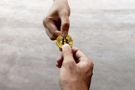 Hands holding bitcoinの写真素材