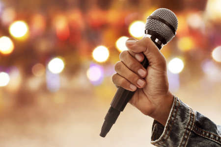 Hand holding microphoneの写真素材