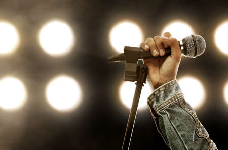 Hand holding microphoneの写真素材