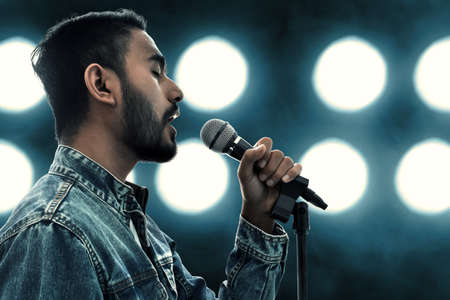 Singer singing with microphoneの写真素材