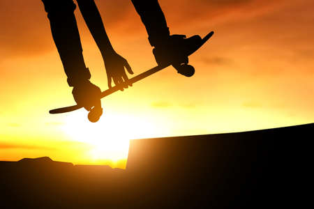 Skateboarder skateboarding at skate park silhouetteの写真素材
