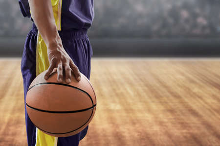 Basketball player holding a ballの写真素材