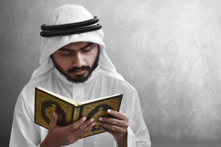Religious arab muslim man reading holy quranの写真素材