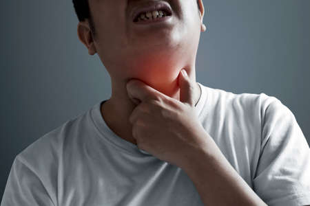Young man with sore throatの写真素材