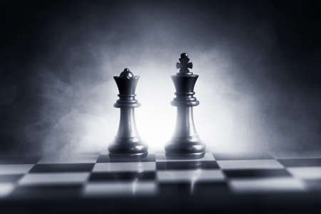 Black king and queen on chess board