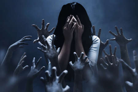 Scared woman on dark background