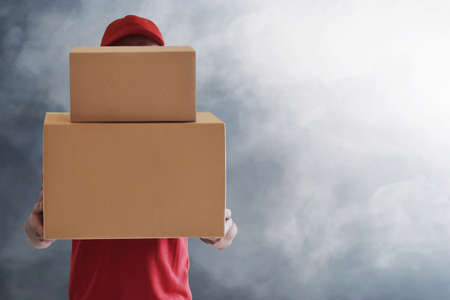 Delivery man on blue backgroundの写真素材