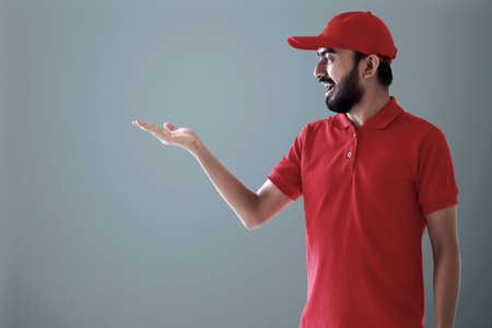 Delivery man on blue backgroundの写真素材