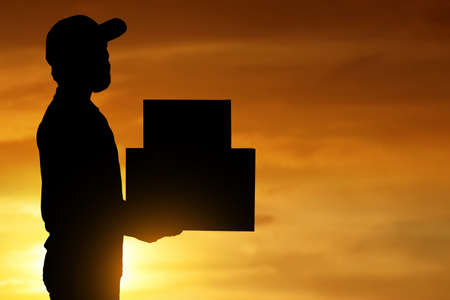 Delivery man on blue backgroundの写真素材