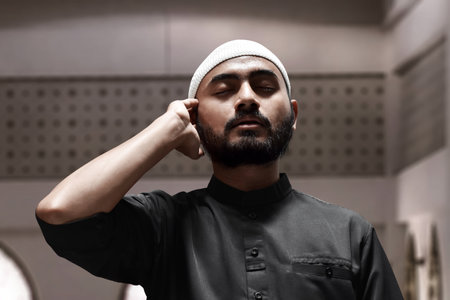 Religious asian muslim man use handphoneの写真素材