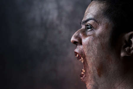 Man possessed on dark backgroundの写真素材