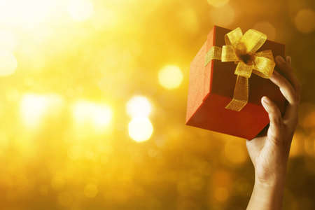 Young man holding gift boxの写真素材