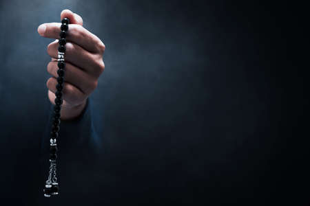 Muslim man praying on dark background