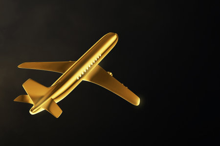 Golden airplane isolated on black backgroundの写真素材