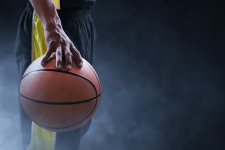 Basketball male player on dark backgroundの写真素材