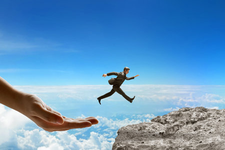 Big hand help businessman jumping on top mountain 3d illustrationの写真素材