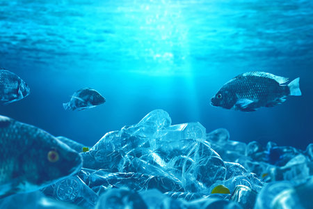 Fish swimming underwater with pile of plastic bottle, Pollution conceptの写真素材