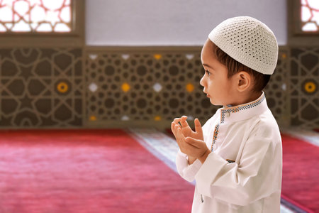Portrait of asian muslim kid praying in the mosque, eid adha mubarak conceptの写真素材